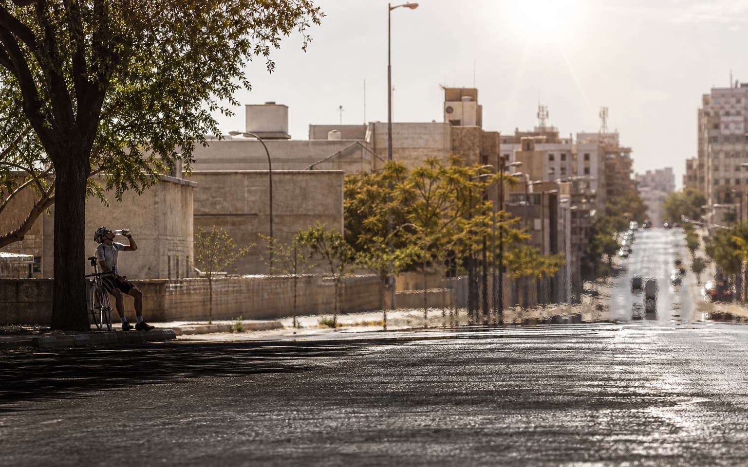 Heat haze over a city street under a harsh verified-record sun